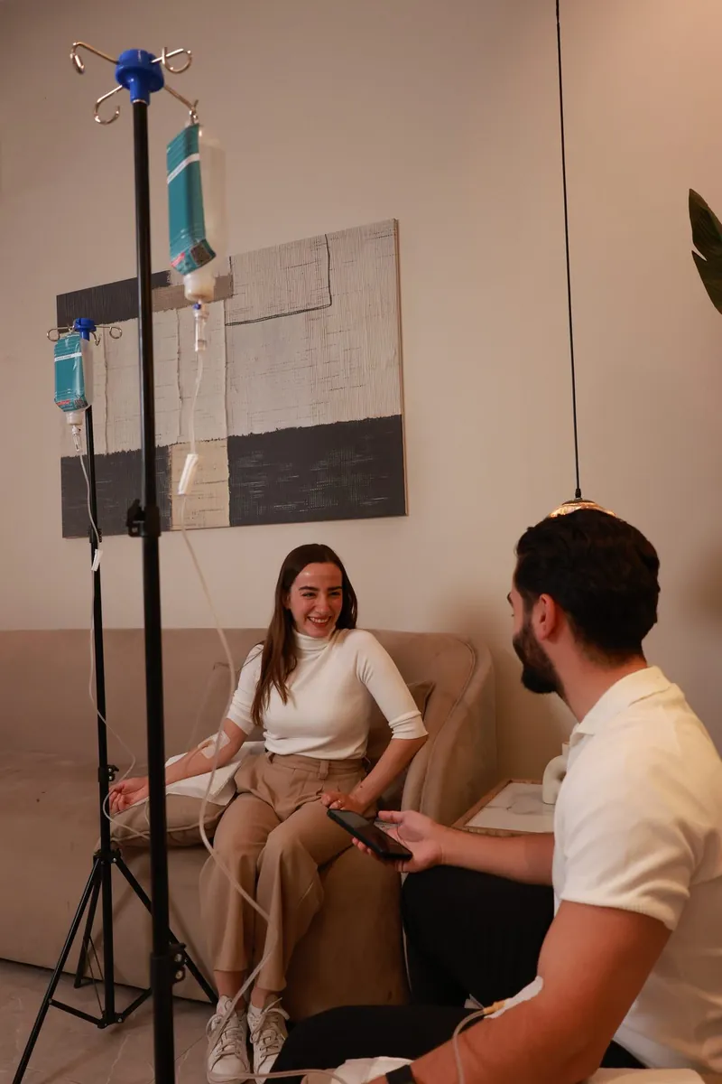 A client receiving an intravenous drip during a session