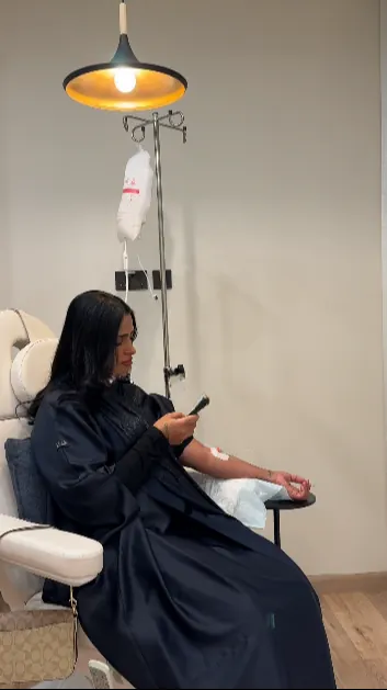 A client receiving an intravenous drip in a treatment chair