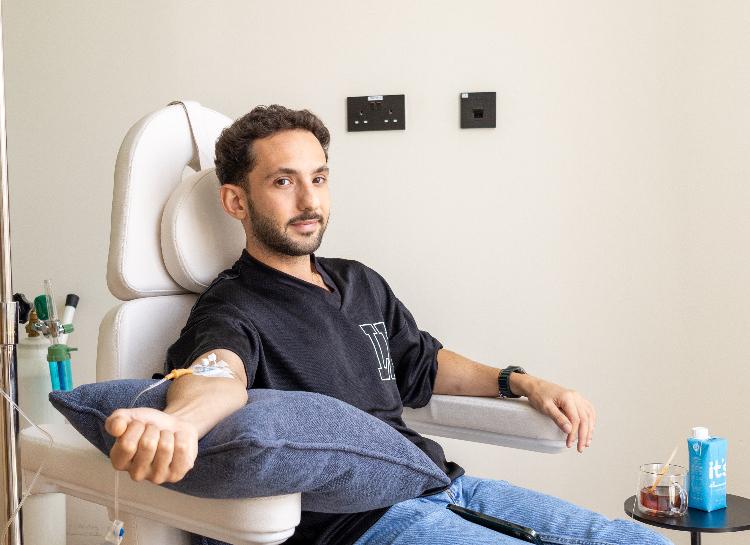 A patient relaxing in a treatment chair during an NAD+ IV drip