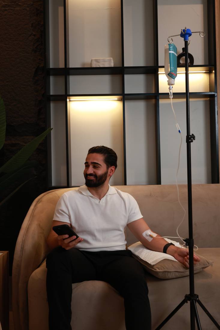 A patient receiving an NAD+ IV drip in the Effect Doctors lounge