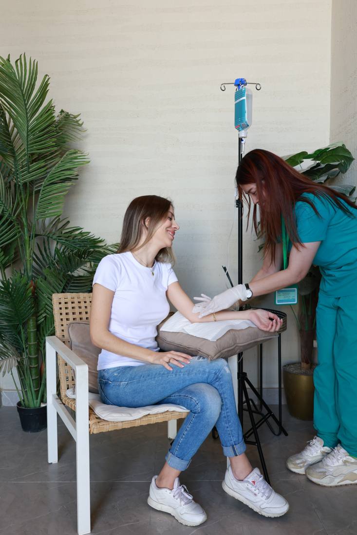 A nurse preparing the IV line before a Myers Cocktail session